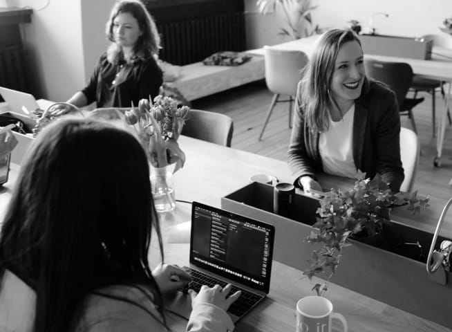 Women coding at their desks.